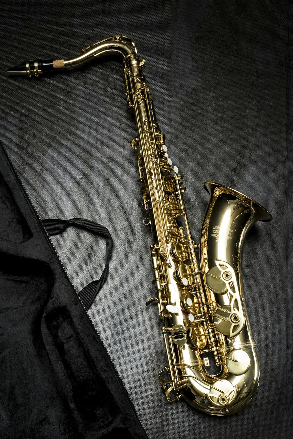 Gold saxophone on dark textured background — Blue Note Logic